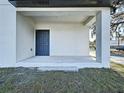 View of the front porch featuring a covered entrance and concrete flooring at 2404 1/2 E Chelsea, Tampa, FL 33610