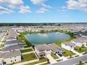 Community with lake, houses, and green spaces at 8861 Forge Breeze Loop, Wesley Chapel, FL 33545
