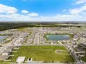 Aerial view of community featuring a lake and various houses at 8861 Forge Breeze Loop, Wesley Chapel, FL 33545