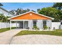 Charming single-story home featuring a carport, grey brick facade, and neatly manicured landscaping at 4607 W San Jose St, Tampa, FL 33629