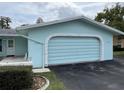 Light blue home with a garage and neatly manicured landscaping at 12026 Boynton Ln # Gb32, New Port Richey, FL 34654