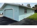 Attached garage with arched door and light blue exterior at 12026 Boynton Ln # Gb32, New Port Richey, FL 34654