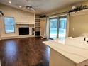 Living room with fireplace and sliding glass doors to the pool at 3582 Fairway Forest Dr, Palm Harbor, FL 34685