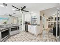 Modern kitchen with white cabinets, granite countertops, and stainless steel appliances at 2735 Quiet Hollow Ct, New Port Richey, FL 34655