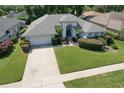 One-story house with gray roof, driveway, and lush green landscaping at 4923 Willow Ridge Ter, Valrico, FL 33596