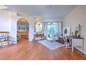 Bright and airy living room with hardwood floors, comfortable seating, and access to other rooms at 4923 Willow Ridge Ter, Valrico, FL 33596