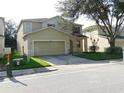 Two-story house with attached garage and well-maintained landscaping at 10605 Marsanne Pl, Riverview, FL 33578