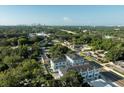 Modern townhouses nestled amongst lush greenery; city skyline view at 6605 N Nebraska Ave # 1, Tampa, FL 33604