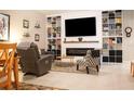 Spacious living room features built-in shelving, fireplace, and comfortable seating at 14117 Weddington Ter, Hudson, FL 34669