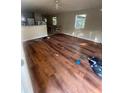 Living room with wood laminate flooring, ceiling fan, and natural light at 10542 Helena St, New Port Richey, FL 34654
