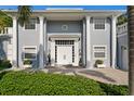 Home exterior showcasing white columns, front door, and manicured landscaping at 45 Adalia Ave, Tampa, FL 33606