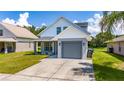 Newly built home with gray garage and well-maintained lawn at 10209 Summerview Cir, Riverview, FL 33578