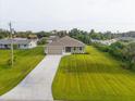 New construction home with a large backyard and paved driveway at 10061 Gulfstream Blvd, Englewood, FL 34224