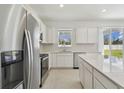 Bright kitchen features stainless steel appliances, granite countertops and ample cabinet space at 4285 Big Sky Dr, Spring Hill, FL 34604