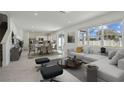 Open-concept living area flows into kitchen with natural light and modern furnishings at 4285 Big Sky Dr, Spring Hill, FL 34604