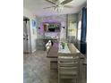 Bright dining area with a farmhouse style table and stone accent wall at 445 Hamden Dr # 505, Clearwater Beach, FL 33767
