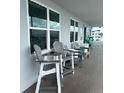 Small patio with gray chairs, providing an outdoor seating area at 445 Hamden Dr # 505, Clearwater Beach, FL 33767