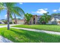 Two-story house with palm trees and a well-maintained lawn at 12929 Prestwick Dr, Riverview, FL 33579