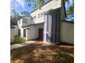 Unique contemporary home featuring stucco exterior, varied window styles and covered front entry at 2400 Pine Hammock, Clearwater, FL 33764