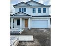 Two-story home with black trim windows and a large two car garage at 318 W Park Ave, Tampa, FL 33602