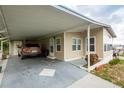 Tan mobile home with carport at 7154 El Meyers St, Zephyrhills, FL 33541