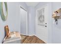 Bright entryway with wood-look floors and a small table at 4474 Connery Ct, Palm Harbor, FL 34685