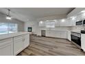 Modern kitchen with white cabinets, stainless steel appliances, and quartz countertops at 17509 Woodthrush Pl, Tampa, FL 33647