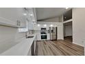 Modern white kitchen with stainless steel appliances and quartz countertops at 17509 Woodthrush Pl, Tampa, FL 33647