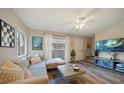 Cozy living room with L-shaped sofa and large TV at 2935 Lichen Ln # C, Clearwater, FL 33760