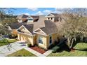 An attractive home with a two-car garage, beautiful landscaping, and a well-maintained lawn in a sunny neighborhood at 20308 Oak Key Ct, Tampa, FL 33647
