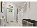 Bright entryway with staircase, storage, and wine cooler at 1333 White Fox Run, Lutz, FL 33549