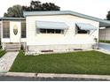 Charming mobile home with a landscaped yard and walkway at 9790 66Th N St # 196, Pinellas Park, FL 33782