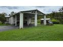 Home with covered carport and storage shed at 17889 Thomas Blvd, Hudson, FL 34667