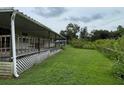 Long covered porch runs along the side of the house at 17889 Thomas Blvd, Hudson, FL 34667