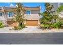 Charming townhome featuring a neutral exterior, two-car garage, and lush landscaping that enhances curb appeal at 1425 Hillside Landing Dr, Tarpon Springs, FL 34688