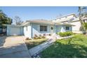 Light blue house with attached garage and walkway at 1843 Oregon Ne Ave, St Petersburg, FL 33703