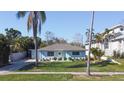 Single-story light blue house, palm trees, and driveway at 1843 Oregon Ne Ave, St Petersburg, FL 33703