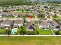 Aerial view showcasing a house with solar panels and a pool at 1100 Multiflora Loop, Lutz, FL 33558