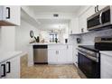 Modern white kitchen with stainless steel appliances and island at 6291 Bahia Del Mar Cir # 103, St Petersburg, FL 33715