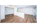 Open living area with hardwood floors and a half wall partition at 1001 Chinaberry Rd, Clearwater, FL 33764