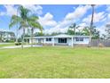 Charming single story home featuring a covered carport and well maintained lawn at 233 W College Ave, Ruskin, FL 33570