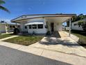 Cozy single-Gathering home with covered carport and freshly cut lawn on a sunny day at 2331 Belleair Rd # Lot 237, Clearwater, FL 33764