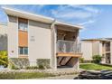 Condo exterior featuring a well-maintained facade, small patio, and manicured landscaping at 621 99Th N Ave # 102, St Petersburg, FL 33702