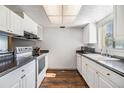 Bright kitchen features white cabinets, dark countertops, and a window for natural light at 621 99Th N Ave # 102, St Petersburg, FL 33702