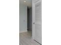 Bright hallway with light grey walls and wood-look floors at 1208 E Kennedy Blvd # 715, Tampa, FL 33602