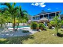 Tropical backyard oasis with a swimming pool and lush landscaping at 262 Banana Rd, Palm Harbor, FL 34683