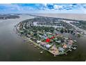 Aerial view showcasing waterfront home and community at 3111 E Vina Del Mar Blvd, St Pete Beach, FL 33706