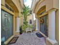 A quaint courtyard with two entrances and a decorative bench at 1361 Emerald Dunes, Sun City Center, FL 33573