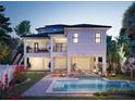 Two-story house with a pool and a landscaped backyard at 625 80Th Ave, St Pete Beach, FL 33706