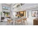 Open concept dining room with modern light fixtures at 8936 Williams Rd, Seffner, FL 33584